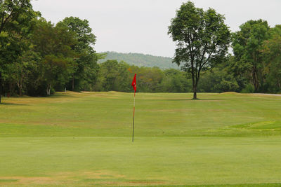 Scenic view of golf course against sky