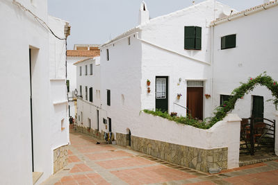 View of the alleys and street white architecture and town of es mercadal, menorca, spain