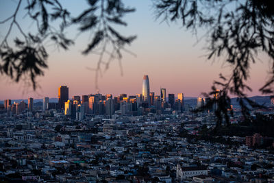 San francisco cityscape view from bernal heights against sky during sunset