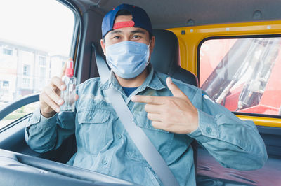 Portrait of young man sitting in car