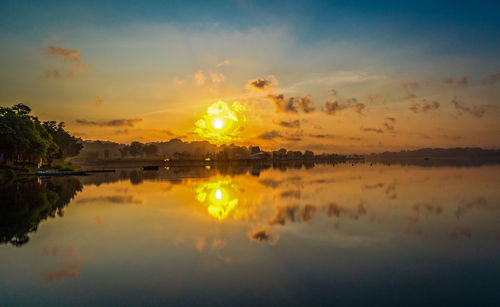 Scenic view of lake against sky during sunset