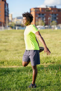 Full length of woman running on grass