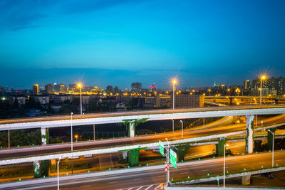 Light trails on road against sky at night