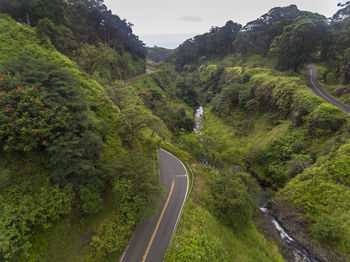 Scenic view of road by mountain against sky