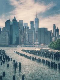 View of skyscrapers against cloudy sky