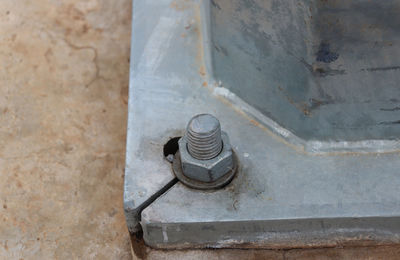 Close up of nut and bolt at base of steel structure