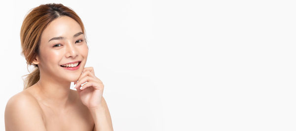 Portrait of a smiling young woman over white background