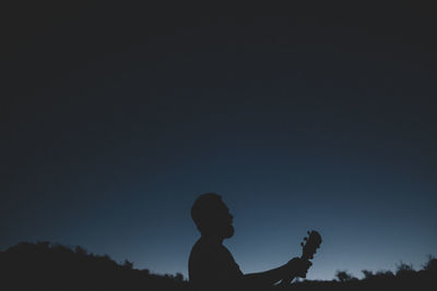 Portrait of silhouette boy against clear sky