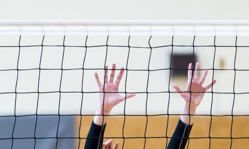 Cropped hands playing volleyball