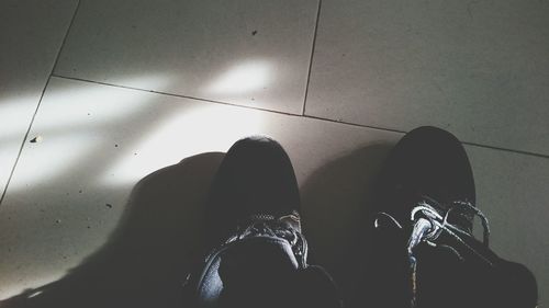 Close-up of woman standing on tiled floor