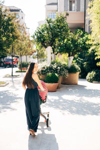 Woman walking on street in city