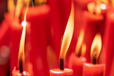 Close-up of lit candles in temple