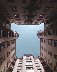 Low angle view of buildings in town against sky