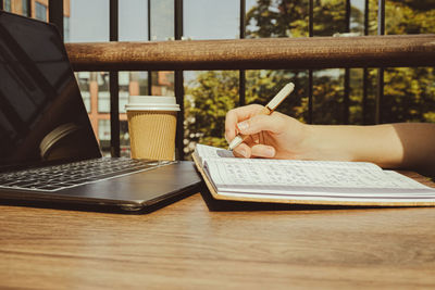 Midsection of man using laptop on table