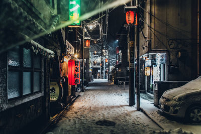 View of railroad tracks at night during winter