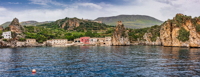 Panoramic view of sea and buildings against sky