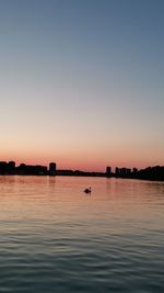 Scenic view of sea against clear sky during sunset