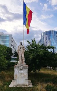 Statue against sky in city