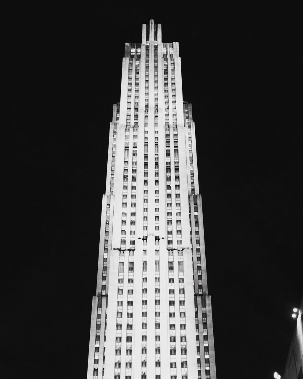 LOW ANGLE VIEW OF MODERN BUILDINGS AGAINST SKY AT NIGHT