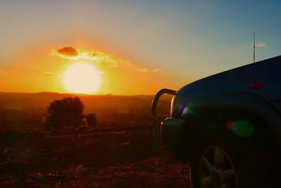 Car on road against sky during sunset