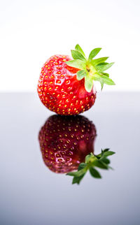Close-up of strawberry on table against white background