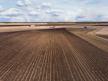 The fields are waiting for the seeds. the clouds are providing the water for the fields.