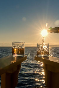 Scenic view of drink against sunset