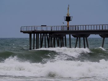 Pier over sea against clear sky