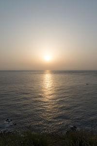 Scenic view of sea against clear sky during sunset