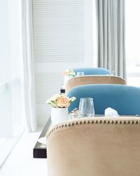 Close-up of flower vase and wineglass on table at restaurant