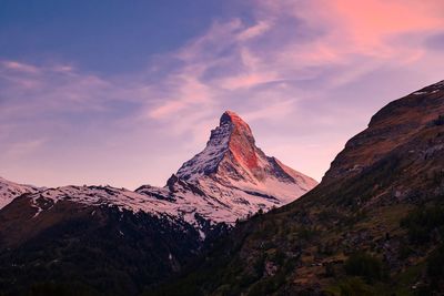 Scenic view of snowcapped mountains against sky during sunset