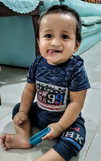 Portrait of cute boy sitting at home