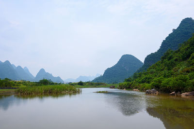 Scenic view of lake and mountains against sky