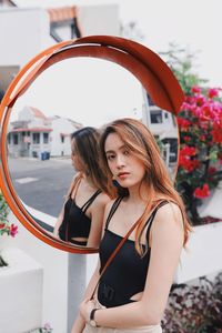 Portrait of a beautiful young woman standing outdoors