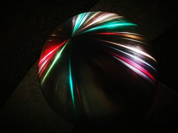 Close-up of illuminated light painting against black background