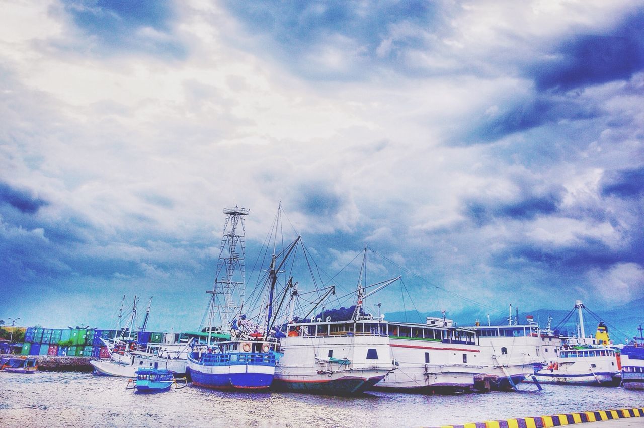 nautical vessel, moored, sky, transportation, mode of transport, boat, cloud - sky, water, sea, cloudy, harbor, cloud, beach, built structure, building exterior, architecture, mast, shore, day, sand