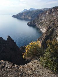 High angle view of rocks by sea against sky