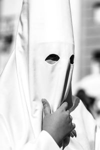 Masked person at holy week processions