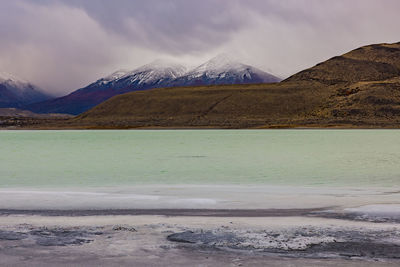 Deep clouds over the mountains at torres del paine at laguna amarga before sunrise, chile, patagonia