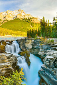 Scenic view of waterfall against sky