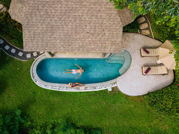 Aerial view of couple relaxing in swimming pool