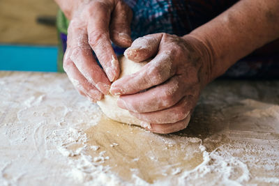 Midsection of person preparing food on table