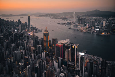 Aerial view of buildings in city during sunset