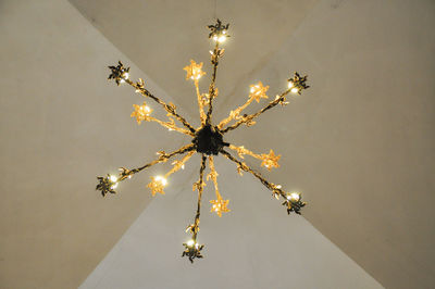 Directly below shot of illuminated chandelier hanging from ceiling