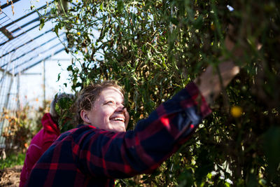 Portrait of smiling young man against plants