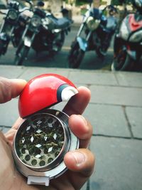 Close-up of hand holding eyeglasses on street