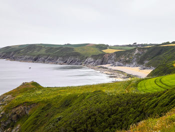 Green meadows, fields, sandy beach and the atlantic ocean, cornish coastline