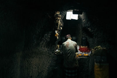 Rear view of men standing in building at night