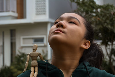 Portrait of young woman looking up