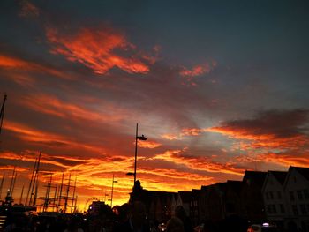 Low angle view of silhouette buildings against dramatic sky